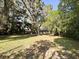 Spacious yard with large, mature trees and lush greenery offering ample shade and a serene setting at 2342 Alice Ave, Eustis, FL 32726