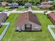 Aerial view of the backyard and exterior of the home with a patio at 2713 Eagle Glen Cir, Kissimmee, FL 34746
