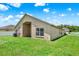 Backyard of the home featuring a well-manicured lawn at 2713 Eagle Glen Cir, Kissimmee, FL 34746