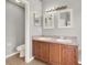 Bathroom vanity features dual sinks and a modern lighting fixture at 2713 Eagle Glen Cir, Kissimmee, FL 34746