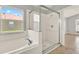 Bright bathroom featuring a soaking tub under a window and separate shower at 2713 Eagle Glen Cir, Kissimmee, FL 34746
