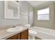 Bathroom features a bathtub with shower, and large vanity at 2713 Eagle Glen Cir, Kissimmee, FL 34746