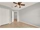 Bedroom with tile floors, ceiling fan, closet and entry door at 2713 Eagle Glen Cir, Kissimmee, FL 34746