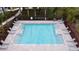 Aerial view of a rectangular community pool with lounge chairs, surrounded by landscaping at 2722 Golden Trout Ln, Edgewater, FL 32141
