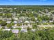 An aerial view displays the neighborhood and mature trees of the property's location at 2728 Hertha Ave, Orlando, FL 32826