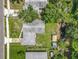 Aerial view of the property showcasing backyard sheds and surrounding tree coverage at 2728 Hertha Ave, Orlando, FL 32826