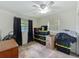 Bedroom featuring a ceiling fan, a window with dark curtains, and boxes stacked on the carpet at 2728 Hertha Ave, Orlando, FL 32826
