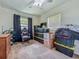 Bedroom featuring a ceiling fan, two windows, and black curtains, boxes stacked on the carpet at 2728 Hertha Ave, Orlando, FL 32826