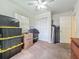 Bedroom with ceiling fan, closet, boxes stacked and dresser and carpet floor at 2728 Hertha Ave, Orlando, FL 32826