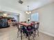 Bright dining area includes an elegant light fixture, table, and chairs at 2728 Hertha Ave, Orlando, FL 32826