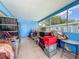 Enclosed tiled patio featuring ample storage space and natural light at 2728 Hertha Ave, Orlando, FL 32826