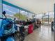 Enclosed patio with tiled floors and a scooter, offering a versatile and bright space at 2728 Hertha Ave, Orlando, FL 32826