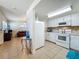 Well-lit kitchen showcases white cabinets and appliances, complemented by tiled flooring at 2728 Hertha Ave, Orlando, FL 32826