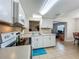 The kitchen has white cabinets, light countertops and tile floors at 2728 Hertha Ave, Orlando, FL 32826
