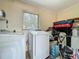 Functional laundry room equipped with a washer and dryer, and window for natural light at 2728 Hertha Ave, Orlando, FL 32826