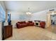 Bright living room with tile floors, couches, entertainment center, and a stone fireplace at 2728 Hertha Ave, Orlando, FL 32826