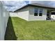 Spacious backyard featuring a well-maintained lawn and a secure fence, offering privacy and space at 2824 Neverland Dr, New Smyrna Beach, FL 32168