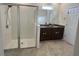 Sleek bathroom featuring double sinks, granite countertops, and a glass-enclosed shower at 2824 Neverland Dr, New Smyrna Beach, FL 32168