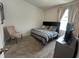 Cozy bedroom with a bed, chair, and a bright window providing a comfortable space at 2824 Neverland Dr, New Smyrna Beach, FL 32168