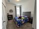 Well lit bedroom featuring cartoon theme decor, carpet floors, and a large window for natural light at 2824 Neverland Dr, New Smyrna Beach, FL 32168
