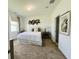 Bright bedroom featuring neutral decor, carpet floors, and a large window for natural light at 2824 Neverland Dr, New Smyrna Beach, FL 32168