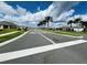 Picturesque street lined with palm trees and manicured landscaping in Coastal Woods community at 2824 Neverland Dr, New Smyrna Beach, FL 32168