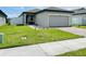 Charming single-story home features an attached garage and well-maintained lawn at 2824 Neverland Dr, New Smyrna Beach, FL 32168