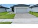 Inviting single-story home with a manicured lawn and brick driveway at 2824 Neverland Dr, New Smyrna Beach, FL 32168