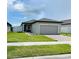 Attractive single-story home with a well-kept lawn, brick driveway, and inviting curb appeal at 2824 Neverland Dr, New Smyrna Beach, FL 32168