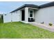 Charming front entrance featuring a black bench, decorative stones, and a white fence at 2824 Neverland Dr, New Smyrna Beach, FL 32168