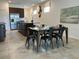 Open-concept kitchen and dining area with stainless steel appliances and modern decor at 2824 Neverland Dr, New Smyrna Beach, FL 32168