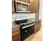 Stainless steel appliances include microwave and stove, and granite countertops with tile floors at 2824 Neverland Dr, New Smyrna Beach, FL 32168