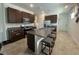 Bright kitchen features granite countertops, brown cabinetry, and stainless steel appliances at 2824 Neverland Dr, New Smyrna Beach, FL 32168