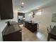 Modern kitchen with stainless steel appliances, a granite island, and dark wood cabinets at 2824 Neverland Dr, New Smyrna Beach, FL 32168