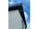 Exterior view of a security camera mounted on the corner of a house against a blue sky at 2824 Neverland Dr, New Smyrna Beach, FL 32168