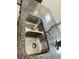 Close-up of a stainless steel dual sink and granite counter top with gooseneck faucet at 2824 Neverland Dr, New Smyrna Beach, FL 32168