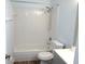 Bathroom featuring white tiled walls, modern toilet, and full sized tub with shower at 2864 N Powers Drive # 156, Orlando, FL 32818