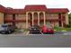 Multi-unit complex with covered parking spaces and a well-maintained exterior at 2864 N Powers Drive # 156, Orlando, FL 32818