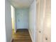 Hallway with white walls and a white door, wood-look floors and a large closet at 2864 N Powers Drive # 156, Orlando, FL 32818