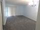 Inviting living room with a light blue paint, grey carpet, and bright sliding glass doors at 2864 N Powers Drive # 156, Orlando, FL 32818