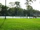 Community tennis court surrounded by a green chain link fence at 2864 N Powers Drive # 156, Orlando, FL 32818