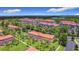Aerial view of community featuring townhomes, lush landscaping, and surrounding green spaces at 3010 Secret Lake Dr, Kissimmee, FL 34747