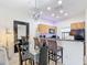 Eat-in dining area with a modern chandelier and bar-style seating at 3010 Secret Lake Dr, Kissimmee, FL 34747