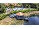 Scenic gazebo on the lake, enhanced by lush surroundings and a clear blue sky at 3010 Secret Lake Dr, Kissimmee, FL 34747