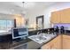 Granite kitchen counter with stainless sink, and view of the living room at 3010 Secret Lake Dr, Kissimmee, FL 34747
