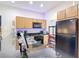Efficient kitchen with a black appliance package and granite countertops at 3010 Secret Lake Dr, Kissimmee, FL 34747
