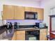 Close-up of the cooking area, including a built-in microwave and electric range at 3010 Secret Lake Dr, Kissimmee, FL 34747