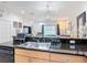 Well-lit eat-in kitchen with granite countertops and stainless sink at 3010 Secret Lake Dr, Kissimmee, FL 34747