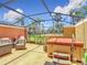 Screened-in lanai with outdoor seating and a hot tub at 3010 Secret Lake Dr, Kissimmee, FL 34747