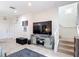 Bright living area with tile flooring, mirrored console and adjacent stairway at 3010 Secret Lake Dr, Kissimmee, FL 34747